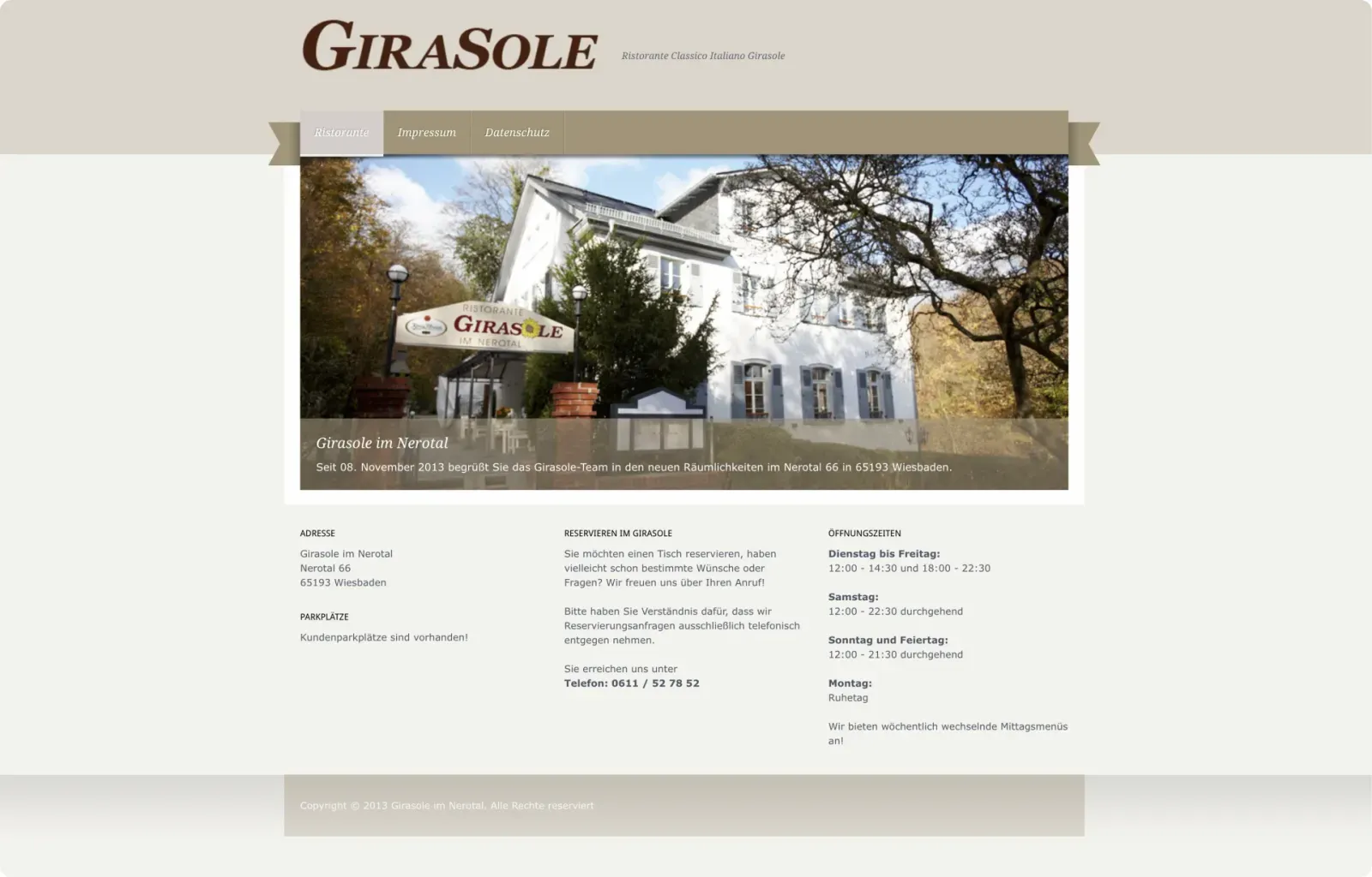 Exterior view of the white building of Restaurant Girasole in Nerotal with garden seating and a sign at the entrance.
