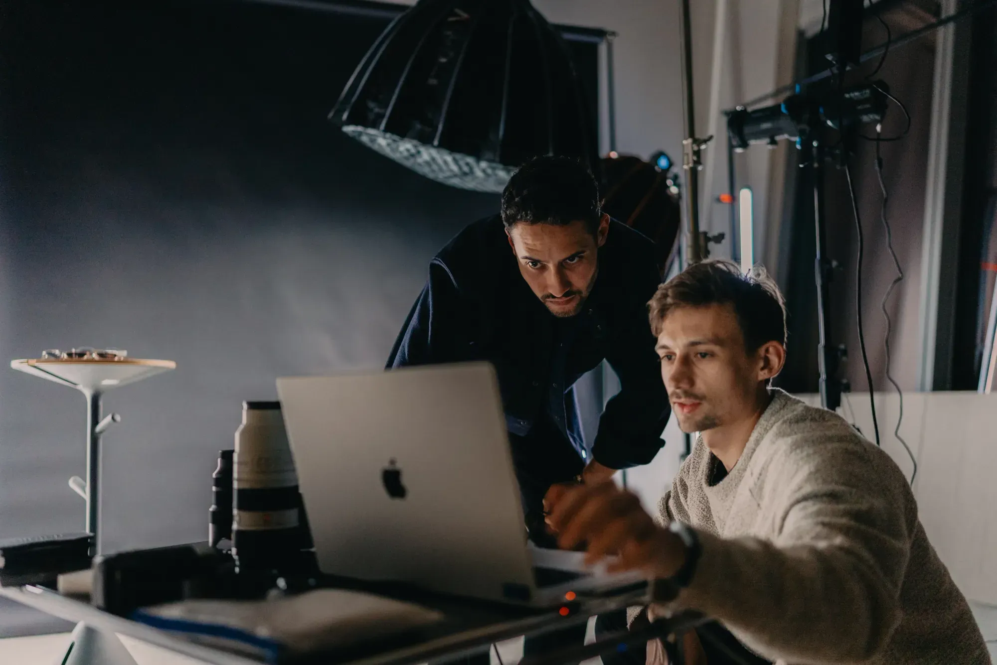 Photo studio: photographer and model reviewing images on a laptop