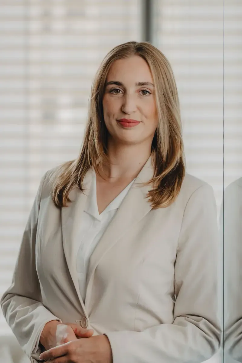 White Bird business portrait: smiling woman in a beige blazer