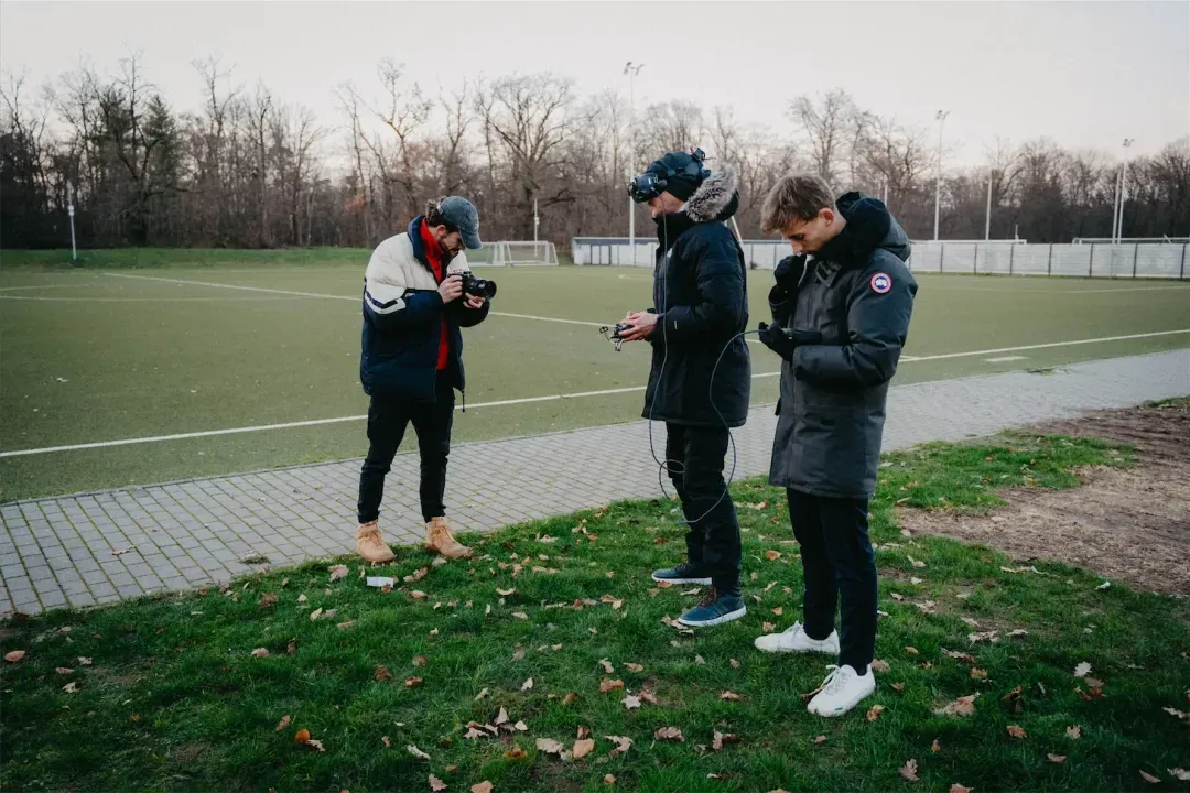SAP behind the scenes: team with camera, VR headset and drone on a sports field