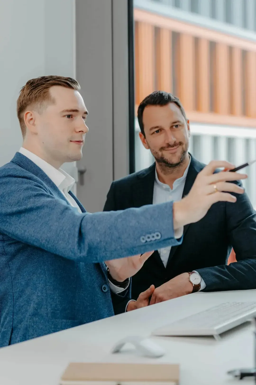 VAP business meeting: two men in suits discussing in the office