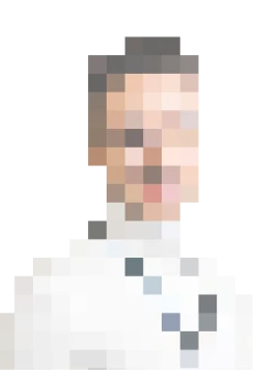 Heavily pixelated portrait photo of a person with dark hair and a white shirt
